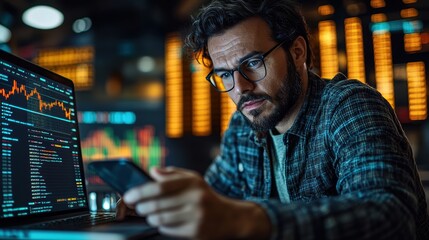 Investor using mobile phone and laptop checking trade market data. Stock trader broker looking at computer analyzing trading cryptocurrency finance market crypto stockmarket data, over shoulder view.