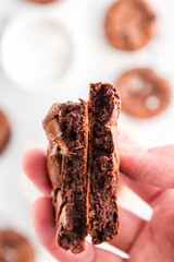 Brownie cookie snapped in half revealing the fudgy interior