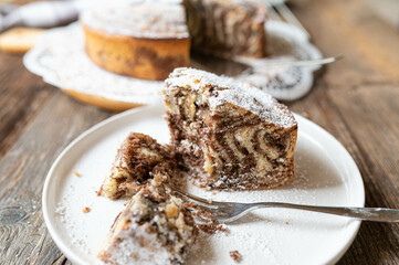 Marble cake with zebra pattern on wooden table