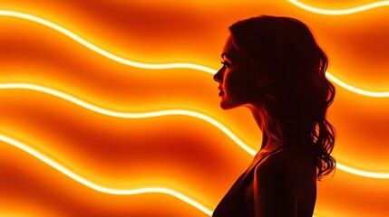 Woman's silhouette against a backdrop of wavy orange neon lights 