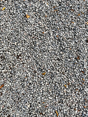 Smooth round pebbles texture background. Pebble sea beach close-up, dark wet pebble and gray dry pebble