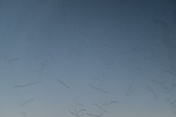 Ice patterns on glass window, selective focus. Frost background from the ice crystals for publication, poster, calendar, post, screensaver, wallpaper, cover. High quality photo
