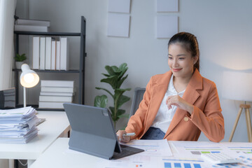 Focused businesswoman analyzing financial data on computer, showcasing professionalism in modern...