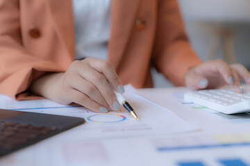 Business Documents concept : Employee woman hands working in Stacks paper files for searching and checking unfinished