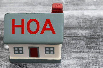 Troubled HOA with a house on weathered wood desk