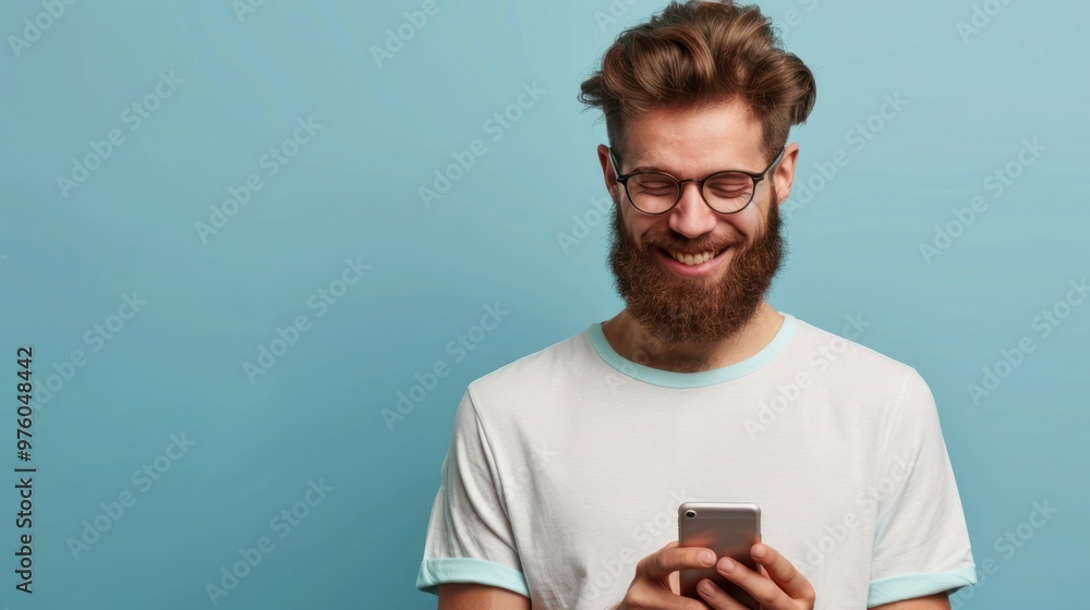 Poster smiling bearded young man student hipster fun blogger glasses hold use modern smart phone smile at s