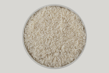 Raw aromatic basmati rice in a round bowl, with fine, long grains and a white base