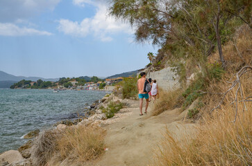 people tourists walking along the sea on the island of Zakynthos