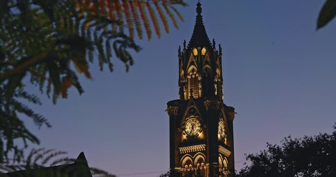 Rajabai Clock Tower In Evening Illumination. Clock Tower In Mumbai India. Confines Of Fort Campus Of University Of Mumbai. It Stands At Height Of 85 M or 280 Ft. Modeled It On Big Ben In London