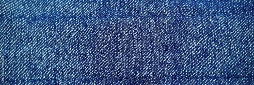 Poster blue denim fabric texture with diagonal weaving patterns and soft lighting, creating a classic and r