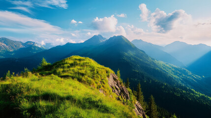 Fototapeta premium A breathtaking view of a majestic mountain range with lush green grass covering the foreground and a clear blue sky above. The image evokes a sense of tranquility, adventure, and the beauty of nature.