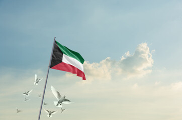 Kuwait flag waving with flying doves in beautiful sky. Kuwait flag for Republic Day and Independence Day.