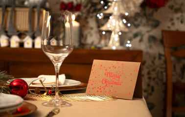 Elegant holiday dinner table featuring a Merry Christmas card