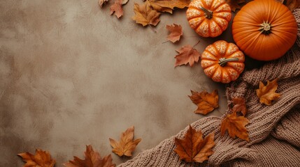 some leaves, orange pumpkins, knitted fabric background