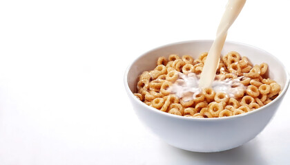 Bowl of Whole Grain breakfast Cereal rings with whole milk isolated on white background with copy space.  Breakfast with milk pouring. Healthy eating concept
