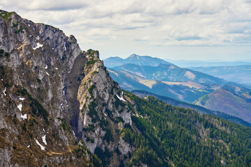 Rugged mountain slope with rocky cliffs and patches of snow. Tatra National Park in Poland. Natural landscape