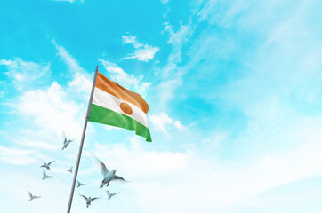 Niger flag waving with flying doves in beautiful sky. Niger flag for Republic Day and Independence Day.
