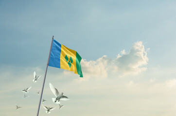 Saint Vincent flag waving with flying doves in beautiful sky. Saint Vincent flag for Republic Day and Independence Day.