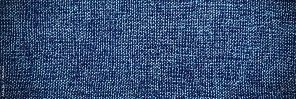 Poster blue denim fabric texture with diagonal weaving patterns and soft lighting, creating a classic and r
