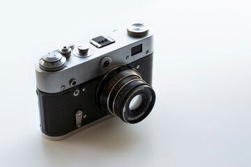 Old retro photo film camera on light background. Vintage style