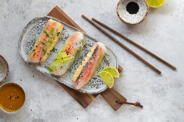Summer rolls with fresh vegetables and smoked tofu served with peanut sauce and lime. Vietnamese...