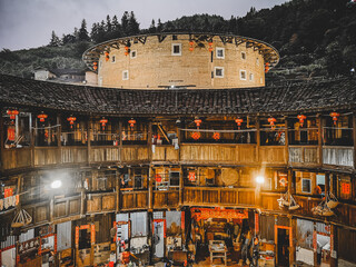 tourists watching view of Huaiyunlou  tulou cluster,is ancient earth dwellings of the Hakka...