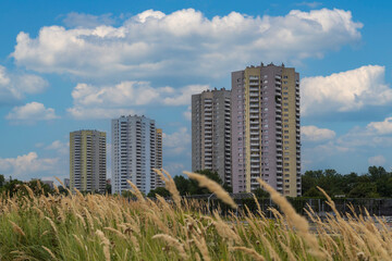 High-rise buildings on the background of blue sky with white clouds