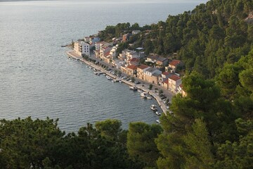 Landscape with detail of shoreline buldings of coastal town Novigrad, sunlit by summer afternoon...