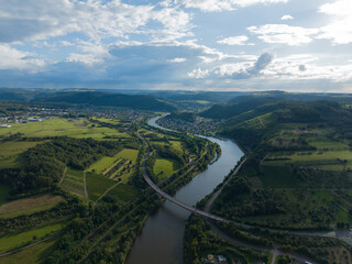 aerial view over the Saar river beautifull hilly landscape in the Saarland region.