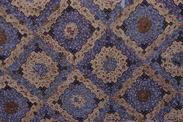 Traditional Indonesian batik fabric with intricate patterns and vibrant colors. Textile design concept