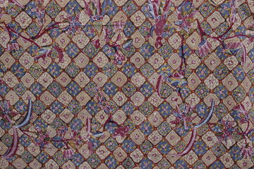 Traditional Indonesian batik fabric with intricate patterns and vibrant colors. Textile design concept