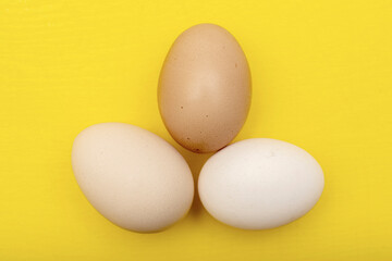 Chiken eggs on yellow background