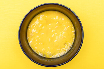 Beaten egg yolks in a bowl