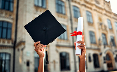  Cropped image of graduate holding academic hat and diploma with red ribbon. Happy graduation,...