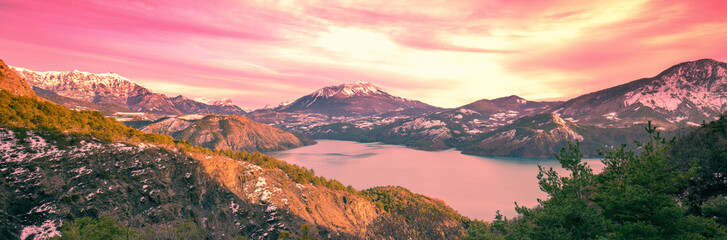 Mountain lake in autumn Aerial view. Serre-Poncon mountain lake in winter in the evening in Hautes Alpes, France. Horizontal banner