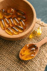 Omega 3 vitamins on dark background, copy space