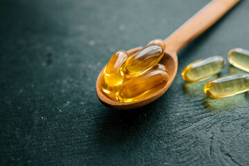 Omega 3 vitamins on dark background, copy space