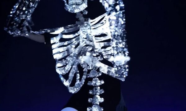 Crystal human skeleton dances on a stage 