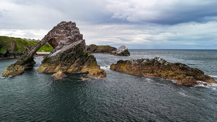 Bird's eye view Ariel drone shot of Bow Fiddle rock, Portknockie, east coast of Scotland