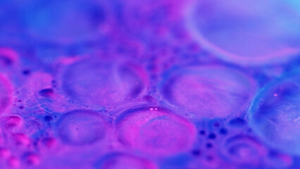 Neon bubbles. Oil foam. Blur purple pink blue color gradient translucent soap texture fizzy ink water blend abstract art background.
