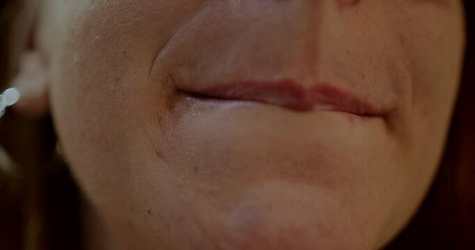 Closeup of a playful woman making funny faces and shapes with her lips and tongue.