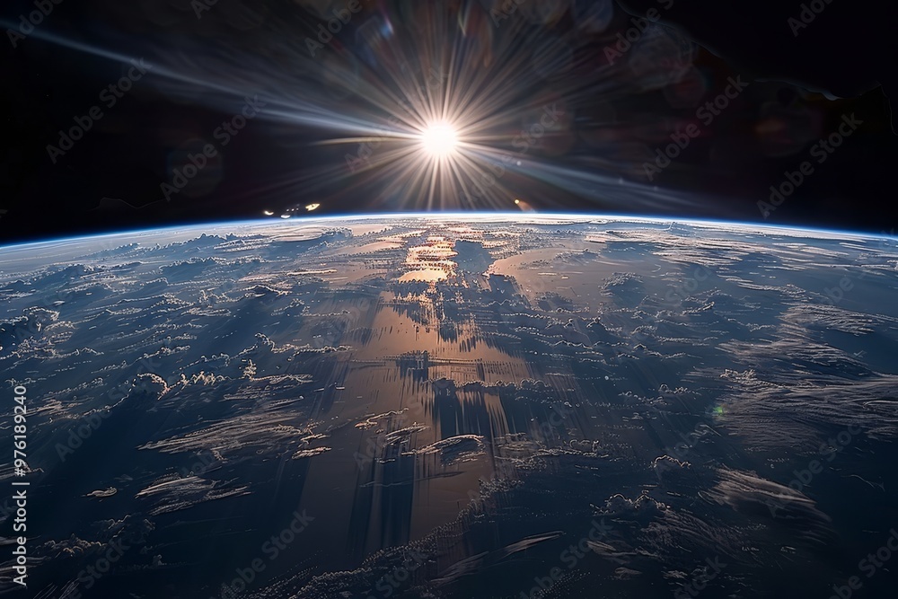 Poster a stunning view captures the sun breaking the horizon over earth, illuminating clouds and oceans whi