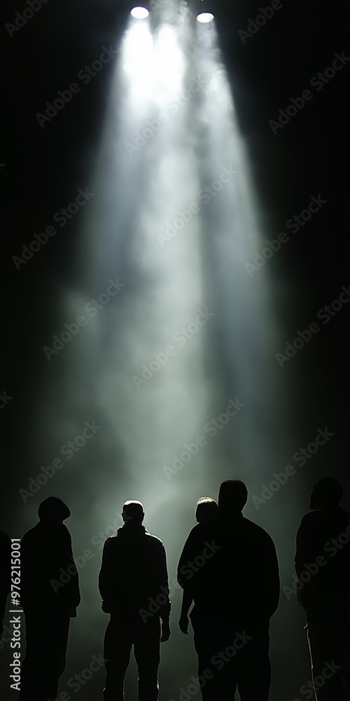 Poster a group of people standing in front of a light, with the light shining on them. scene is mysterious 