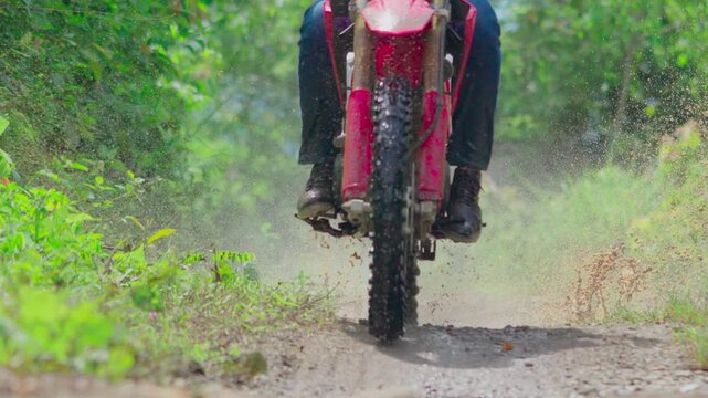 Slow motion video of a man goes on an adventure using an enduro motorbike
