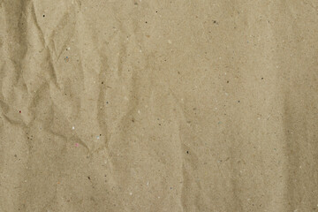 Recycled brown paper, with wrinkled and crumpled texture, with creases, and volumetric shadows