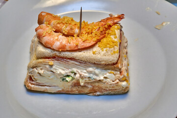 Close-up of shrimp sandwich garnished with crispy toppings