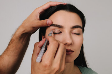 Marking blepharoplasty. Doctor is drawing up plan for upper eye lid surgery with medical marker....