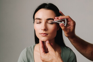 Castroviejo caliper to draw symmetrical contour for eyelid surgery. Blepharoplasty marking up....