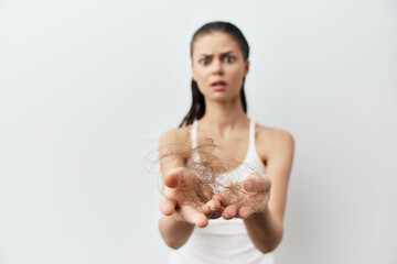 Hair loss, concern, beauty, health issues, woman with hair in hands against white background,...