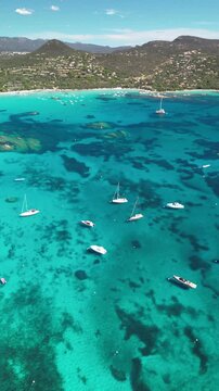 Breathtaking view of the turquoise bay and Santa Giulia beach in Corsica, recorded by drone in vertical format. Perfect content for social media and mobile apps.